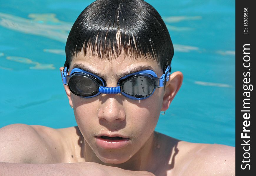 Boy having a rest after long swimming in the pool. Boy having a rest after long swimming in the pool.