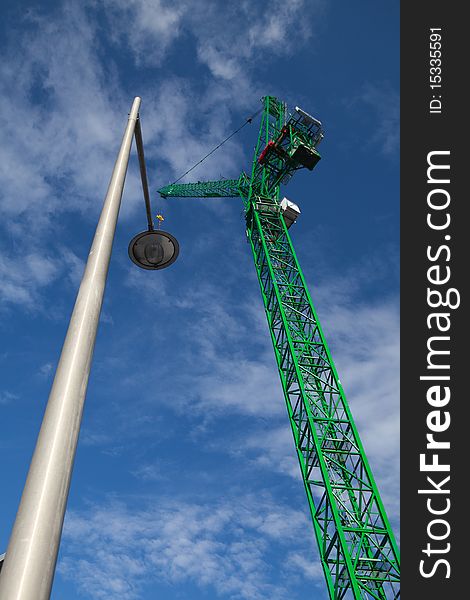 Column crane and lamp on the blue sky