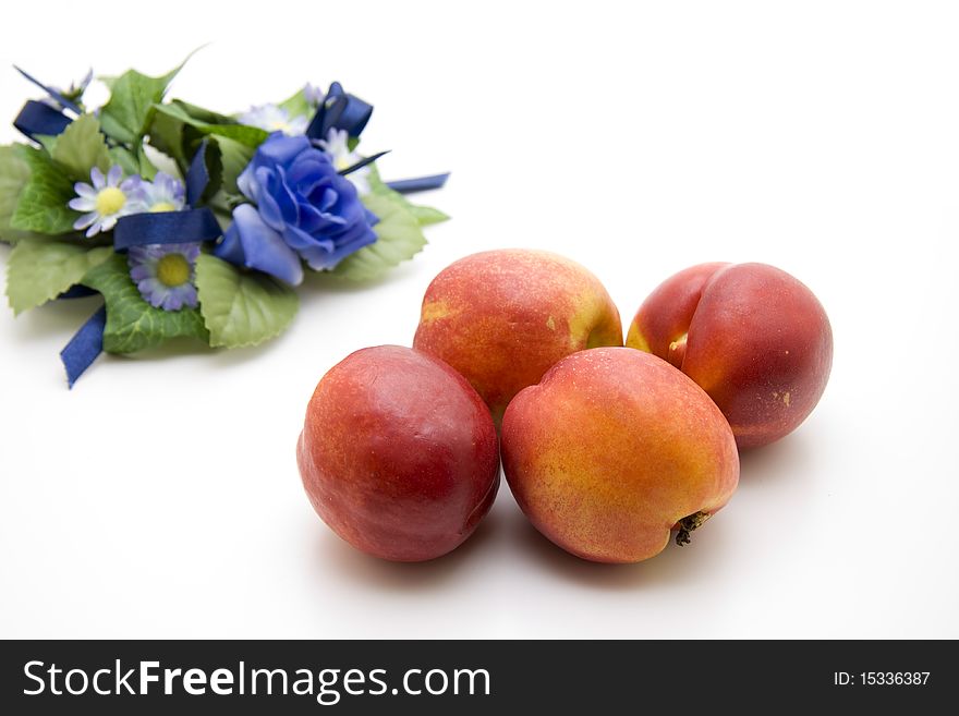Fresh nectarines with blue bunch of flowers. Fresh nectarines with blue bunch of flowers