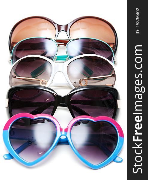 Much sunglasseses put in row on white background