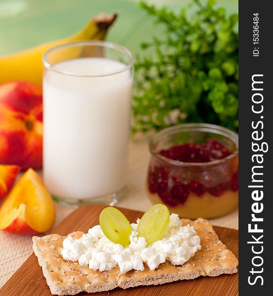 Breakfast with milk and fruits and crispbread on a table