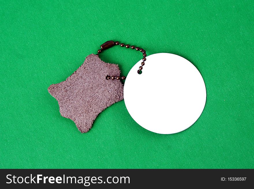 Black empty tag with a green cord isolated on a white background