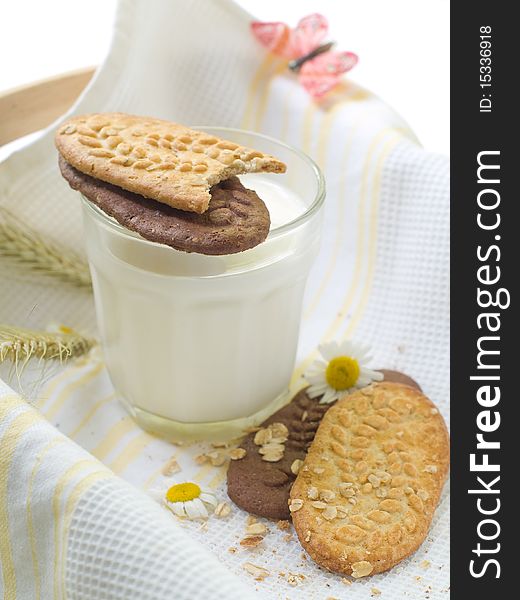Glass of milk and cookies on light kitchen towel. Glass of milk and cookies on light kitchen towel