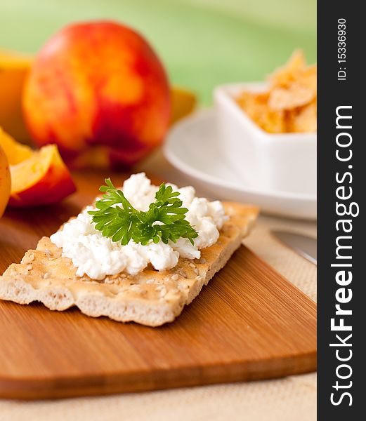 Fresh crispbread to breakfast with cottage cheese and fruits in background. Fresh crispbread to breakfast with cottage cheese and fruits in background