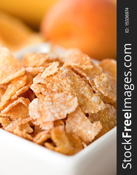 Cornflakes in closeup in a white bowl. Cornflakes in closeup in a white bowl