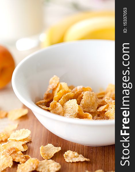 Cornflakes in a white bowl on a table