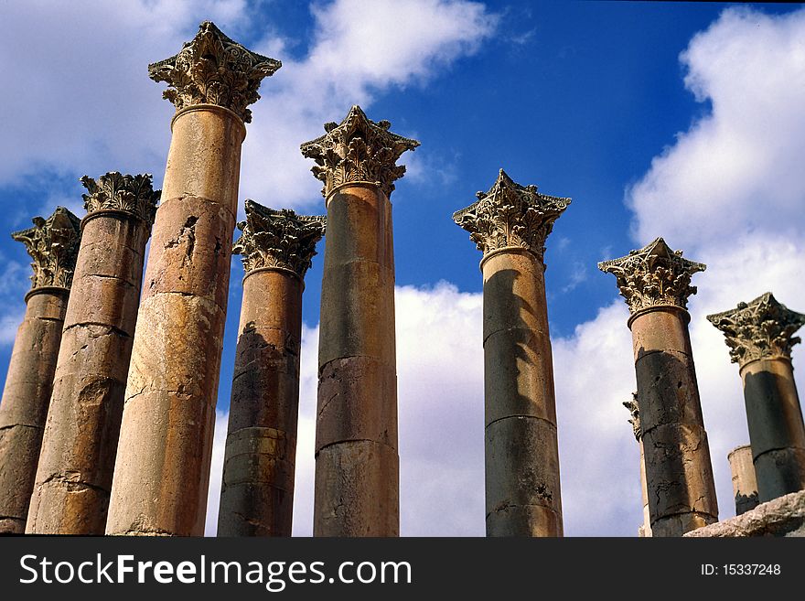 Old corinthian pillars from roman empire in Jerash, Jordan against blue sky. Old corinthian pillars from roman empire in Jerash, Jordan against blue sky