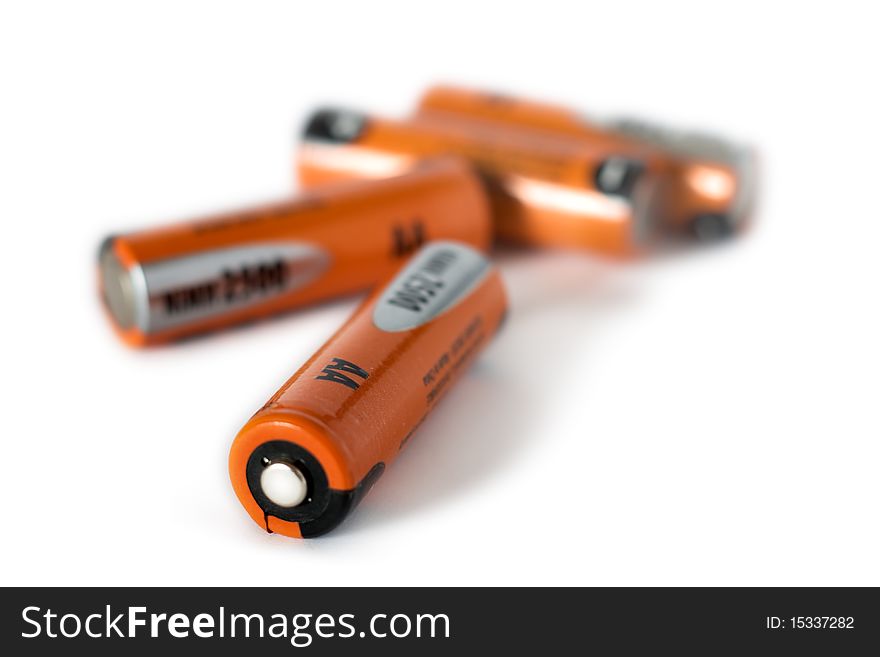 Closeup of orange batteries isolated on white. Closeup of orange batteries isolated on white