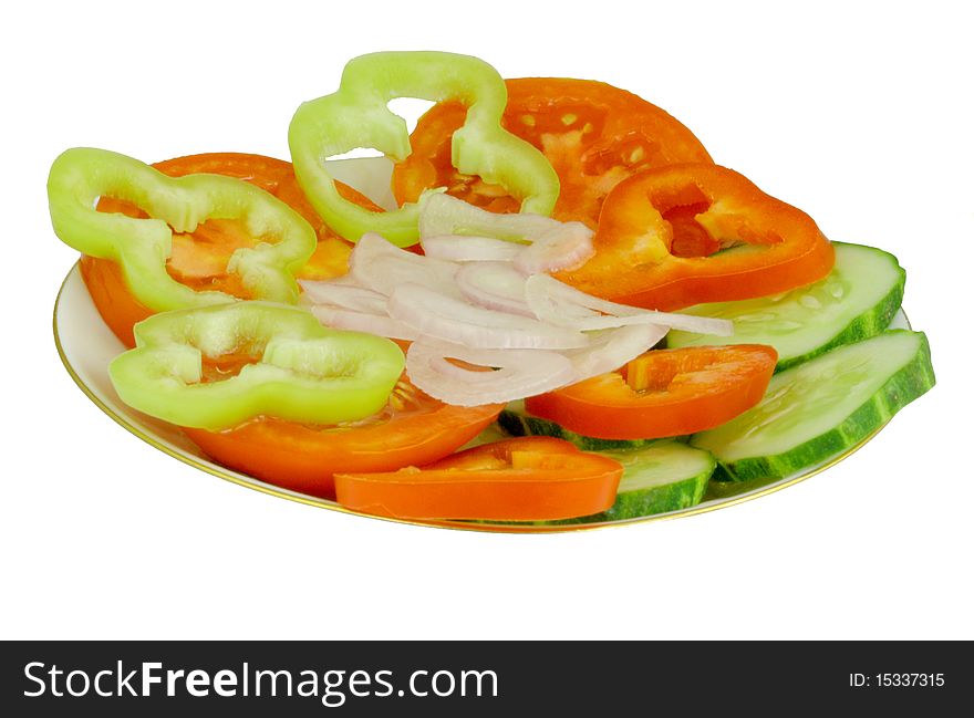 Red ripe tomatoes, green peppers and red, green cucumber and pink bow on his plate, pieces of vegetables on white background. Red ripe tomatoes, green peppers and red, green cucumber and pink bow on his plate, pieces of vegetables on white background