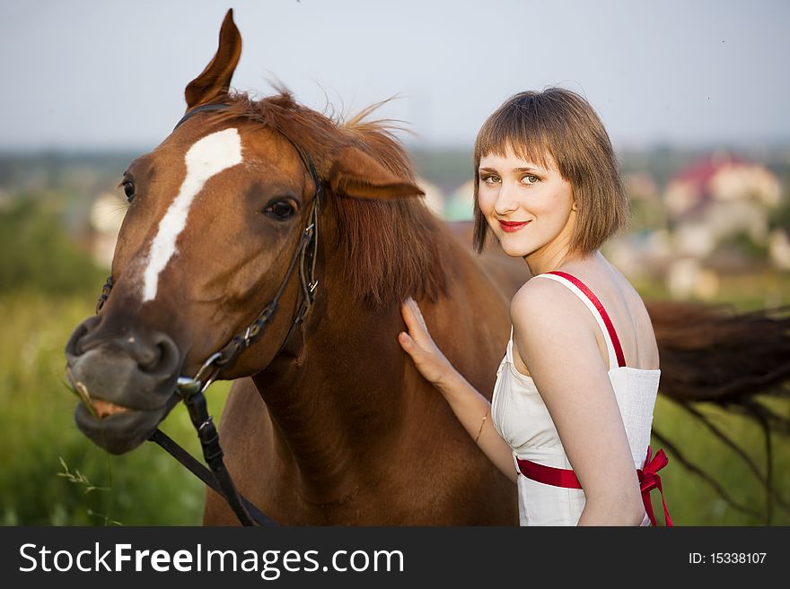 Young woman with horse in the field. Young woman with horse in the field