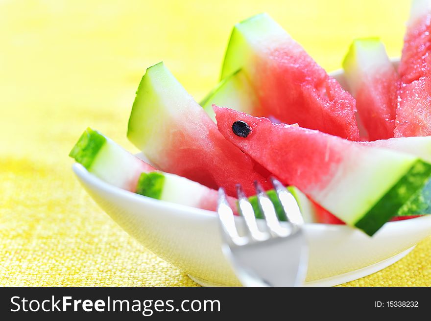 Fresh sliced watermelon in studio on yellow background