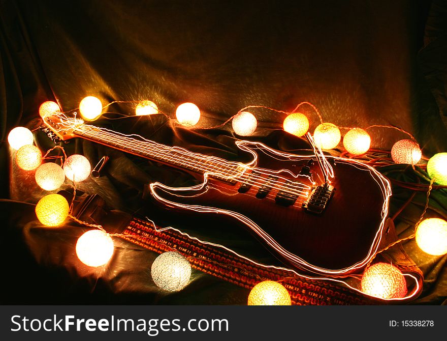 Electric guitar surrounded by lights