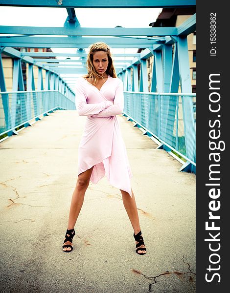 Young woman standing alone on the bridge