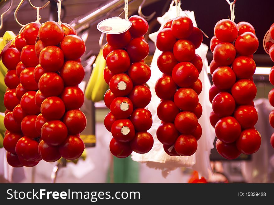 Ripe tomatoes hanging on the market to be sold