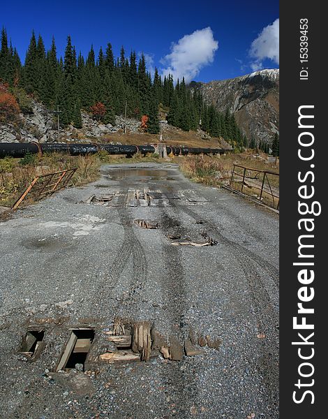 Broken bridge with tyre tracks on the road to Big Almaty Lake in Kazakhstan. Broken bridge with tyre tracks on the road to Big Almaty Lake in Kazakhstan