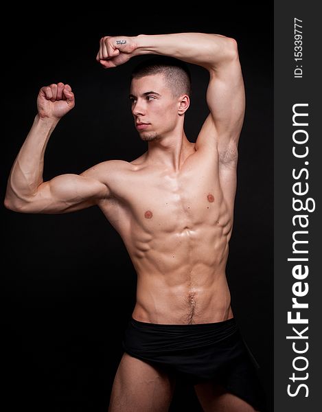 Muscled male model posing in studio