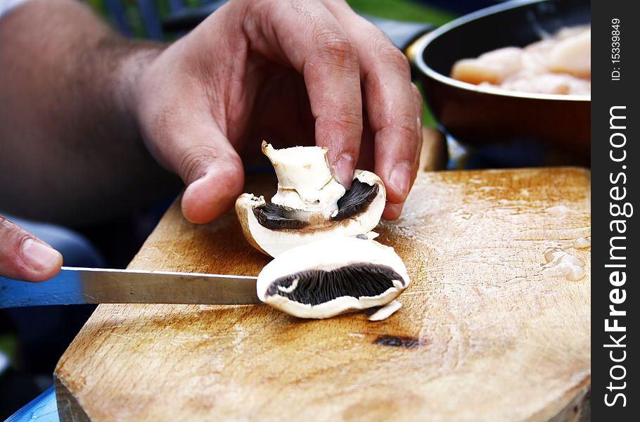 Cutting mushroom on wooden board