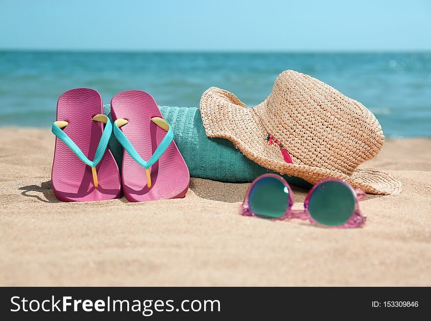 Set of different beach objects on sand near sea