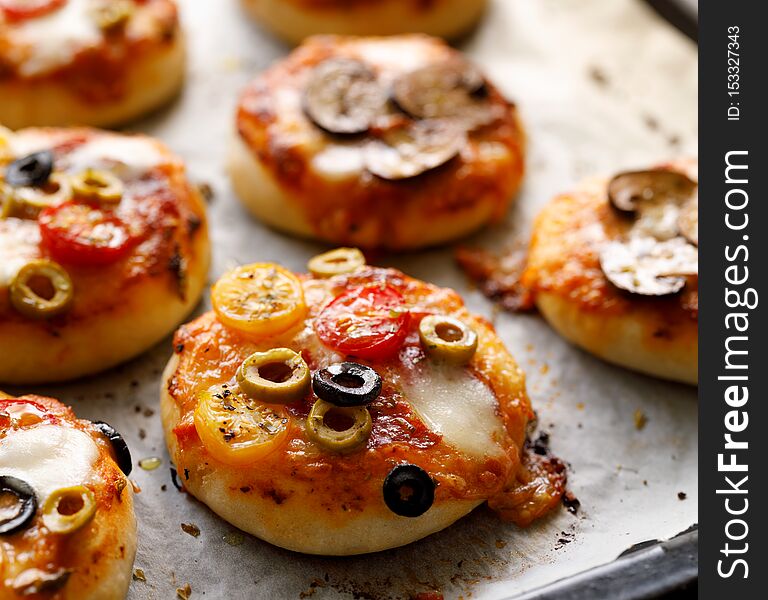 Small vegetarian pizzas with the addition various kinds of vegetables and mozzarella cheese and fresh basil