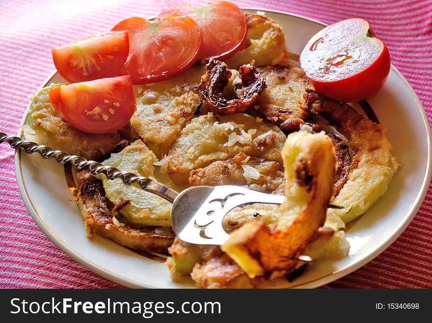 Appetizing fry garden marrow with garlic seasoning