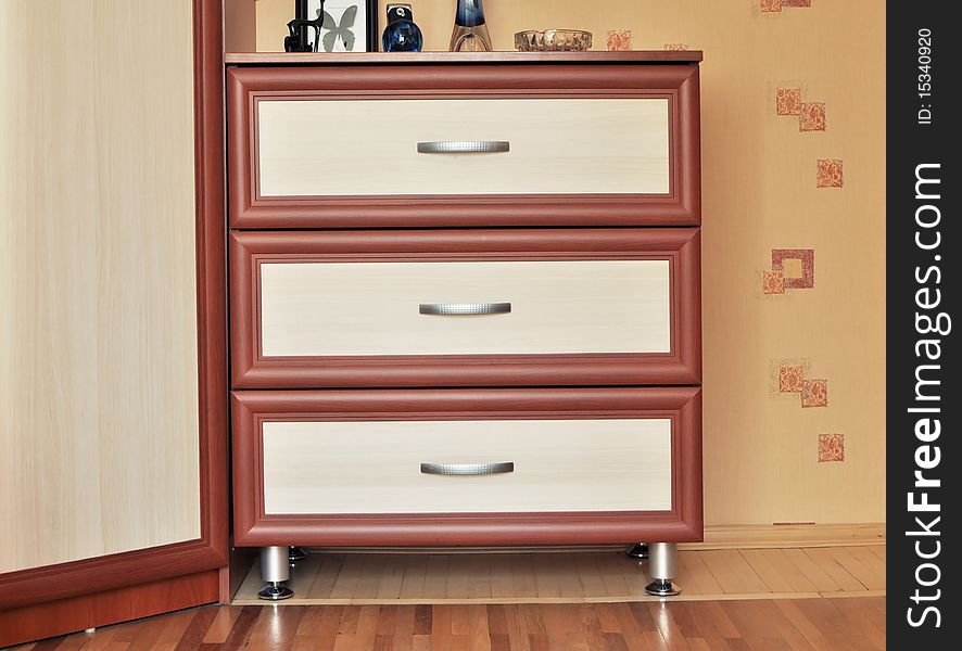 Beautiful bedroom Interior Design detail image featuring wooden bureau