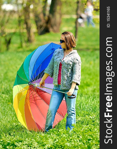 Beautiful woman with umbrella in rainbow colors