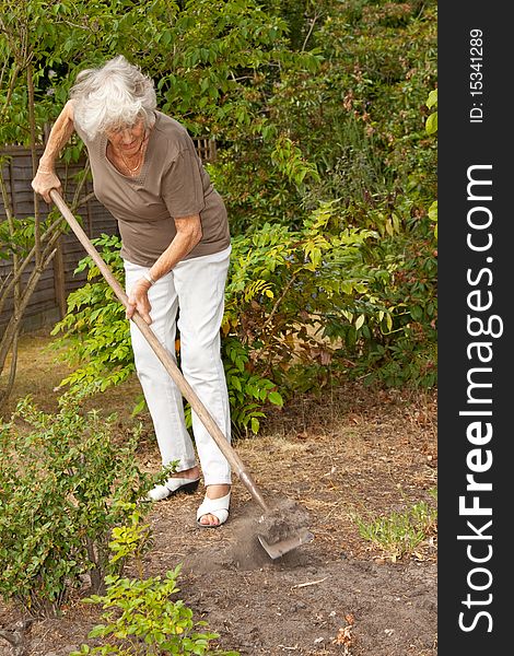 Senior lady gardener doing a little maintenance work. Senior lady gardener doing a little maintenance work