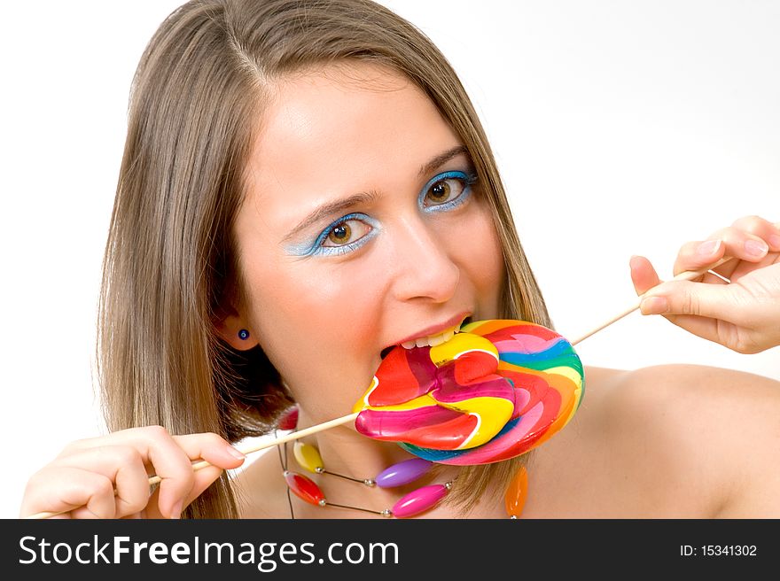 Pretty young woman with colorful lollipop, indoor image
