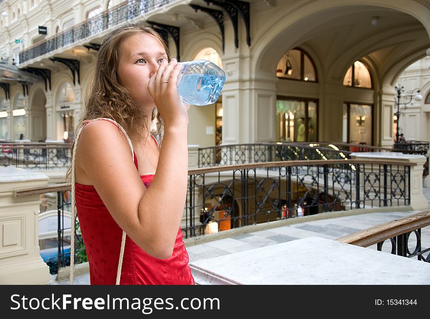 Adorable woman is quenching her thirst