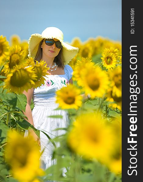 Beautiful woman on sunflower field in summer