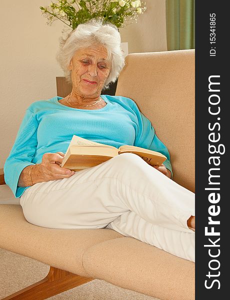 Senior lady relaxing with a good book to read. Senior lady relaxing with a good book to read