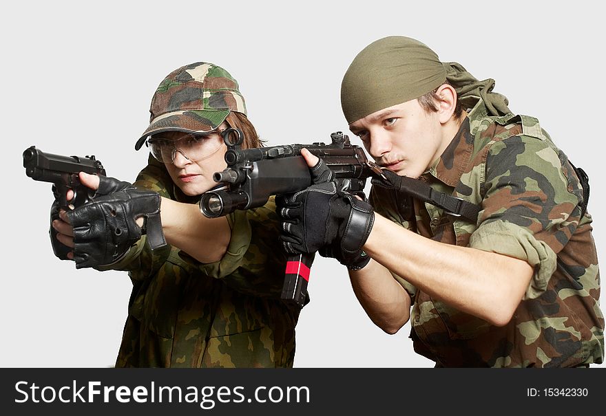 Portrait of soldiers up in arms on a light background