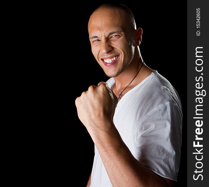 Young male filipino model over a black background is gesturing with his hand. Young male filipino model over a black background is gesturing with his hand.