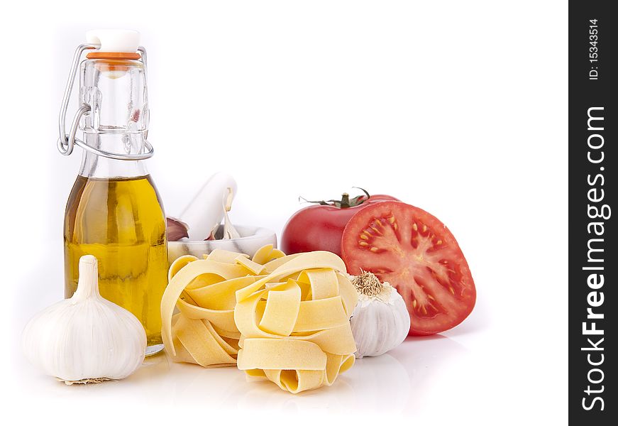 Tomato, garlic,pasta and olive oil on white background