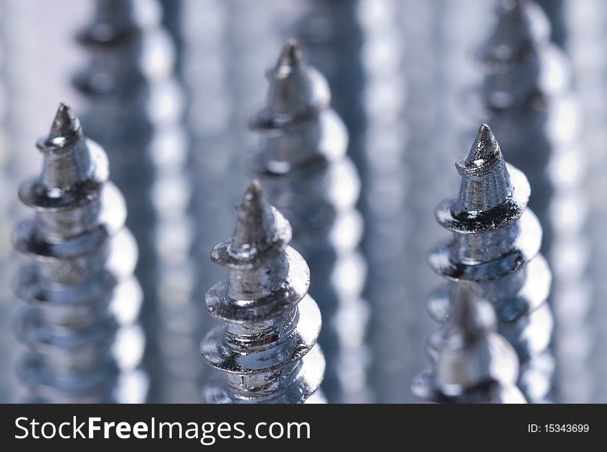 Close-up of silver screws as technology background. Close-up of silver screws as technology background