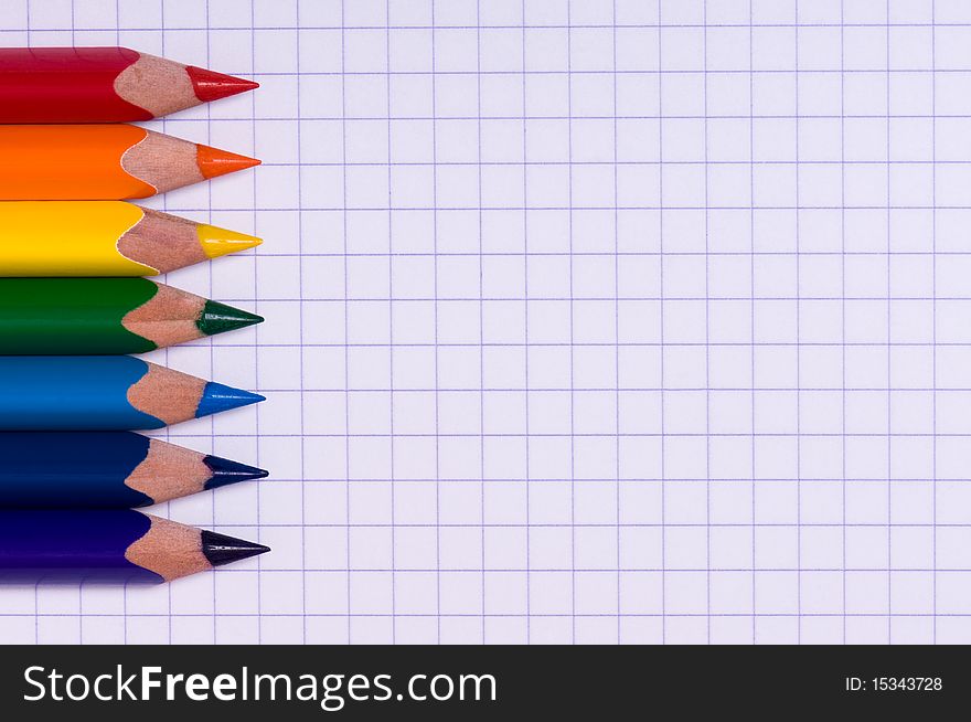Close-up image of multicolor pencils on paper background