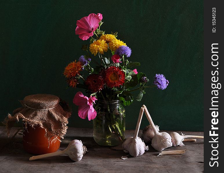 Still Life With Different Flowers And Jar Of Jam