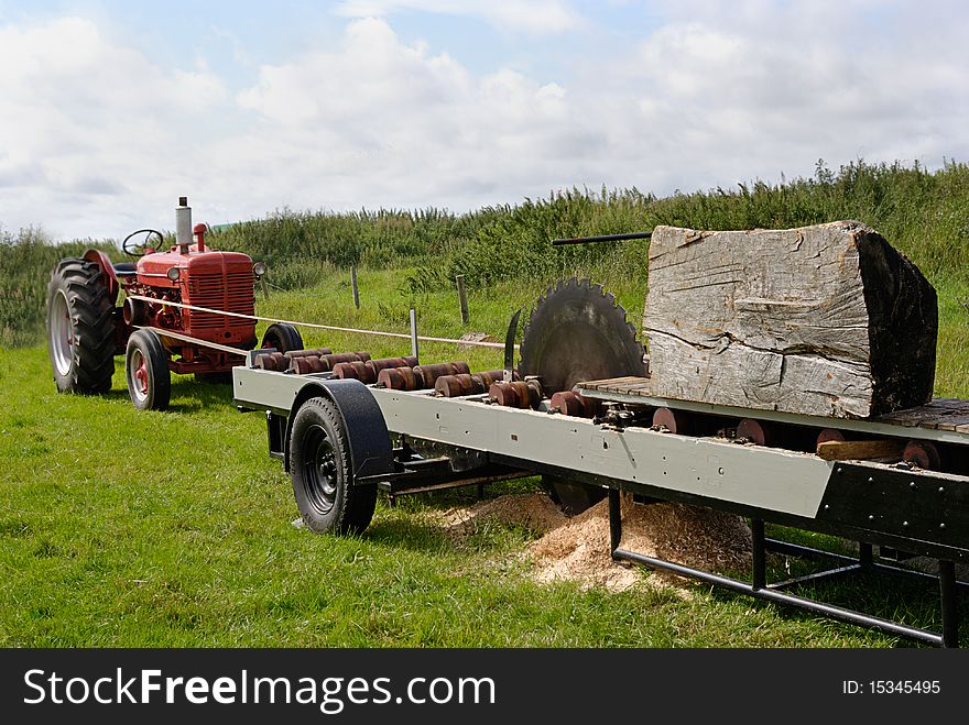 An image of a tractor powered circular saw. An image of a tractor powered circular saw.