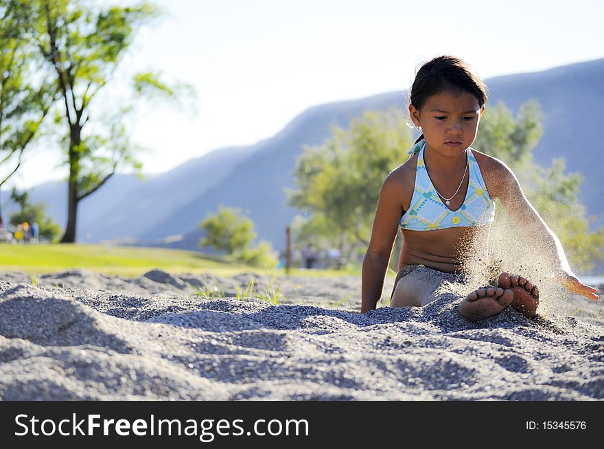 girl playing in the sand. girl playing in the sand