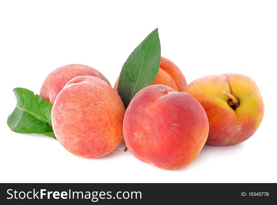 Five peaches on a white background with leaves