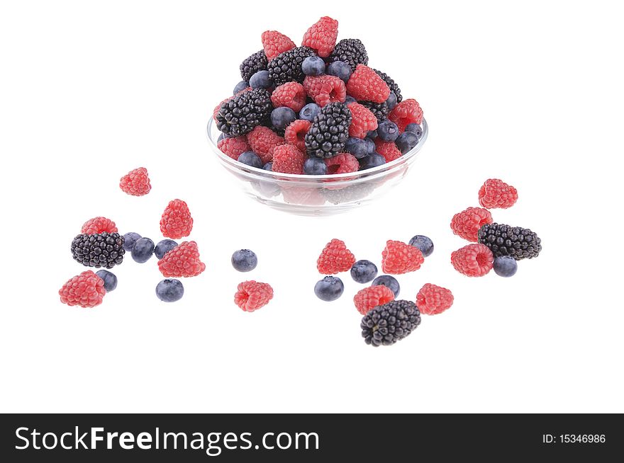 Pot of raspberries, blueberries and blackberries on a white background