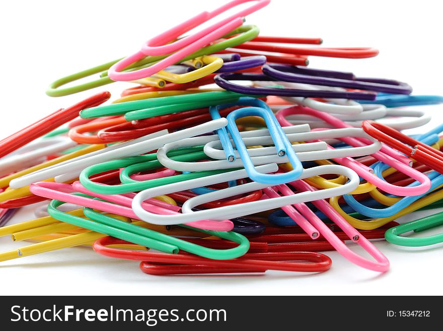 Macro photo of a pile of colorful paper clips isolated on a white background. Macro photo of a pile of colorful paper clips isolated on a white background.