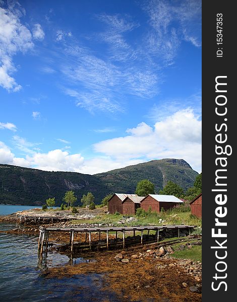Old wooden pier and the boathouses, shot in Norway in Sognefjord. Shot in sunny beautifull day.
