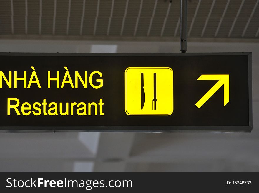 A restaurant marker board writen in VietNam and english character, and direction indicator.
