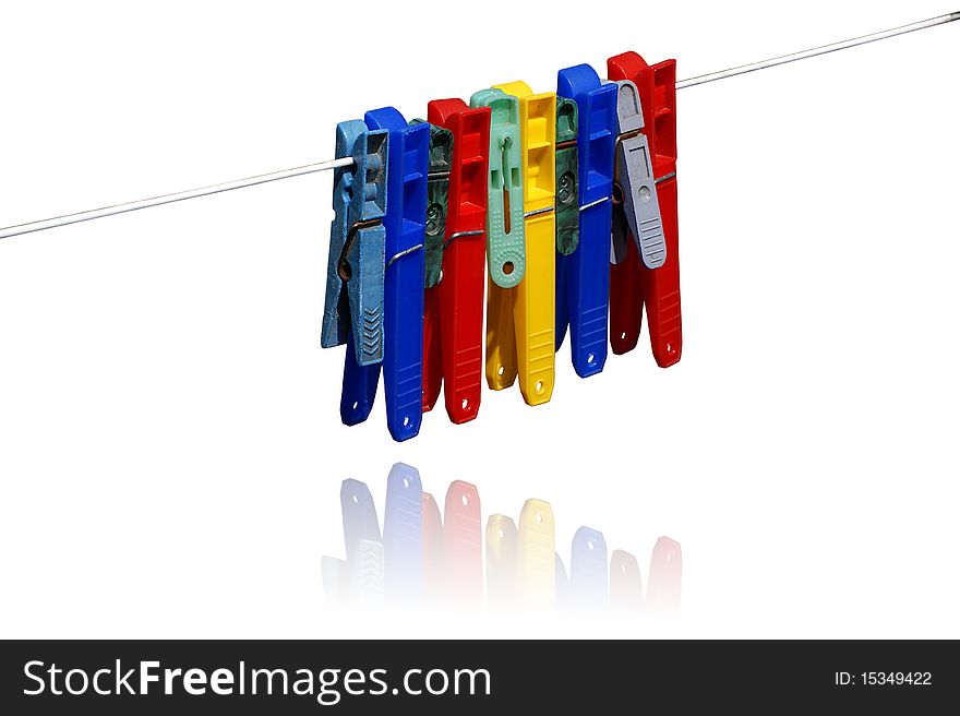 Color clothes pins in white background