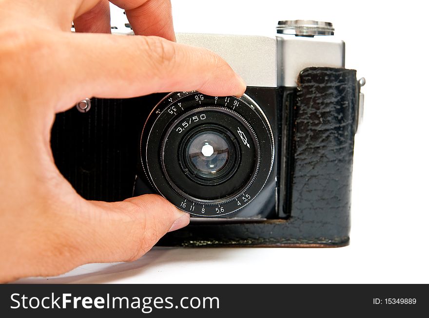 Old manual film camera and hand isolated on white. Old manual film camera and hand isolated on white