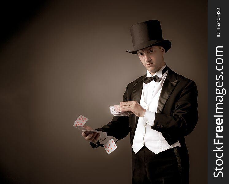 Magician holding playing cards