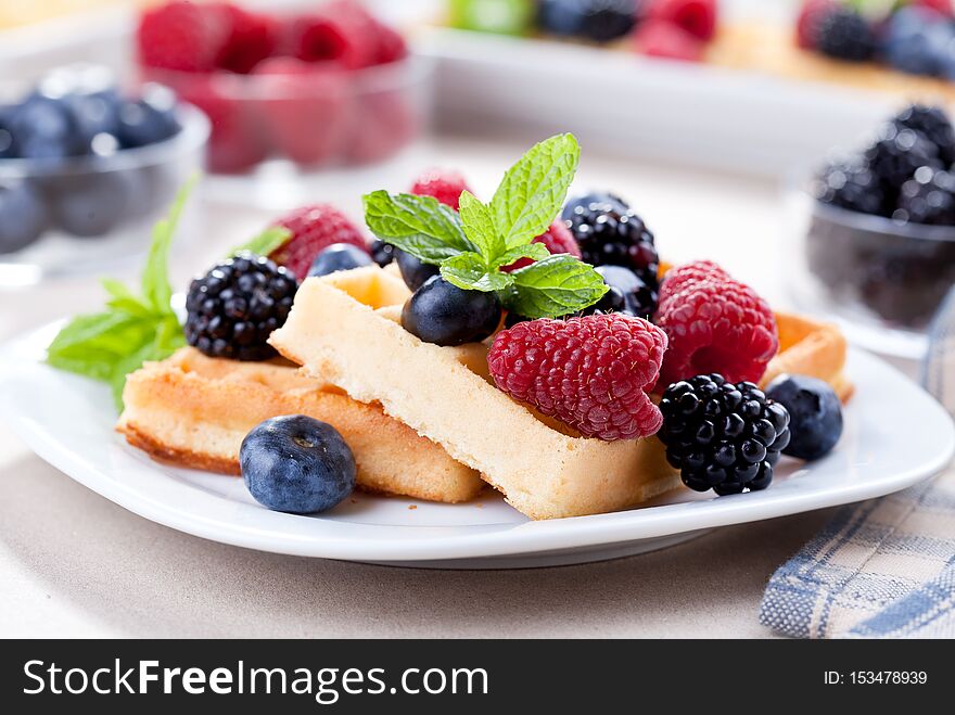 Close up of a couple of waffles with berry fruits. Close up of a couple of waffles with berry fruits