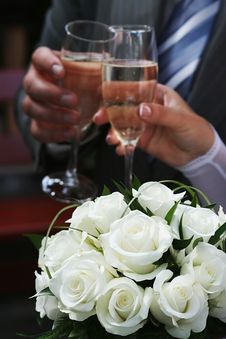 White Roses And Two Hands Holding Goblets. Stock Photo White Roses And Two Hands Holding Goblets. Stock Photo