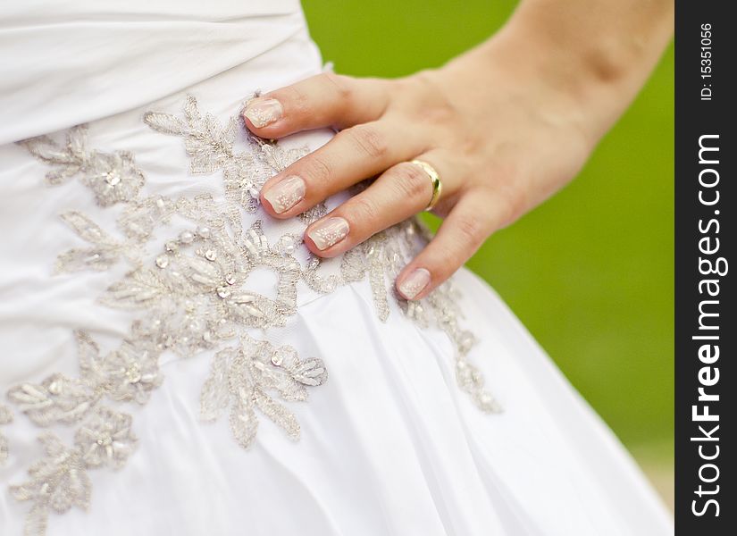 Beautiful white wedding dress and human hand with ring closeup. Beautiful white wedding dress and human hand with ring closeup